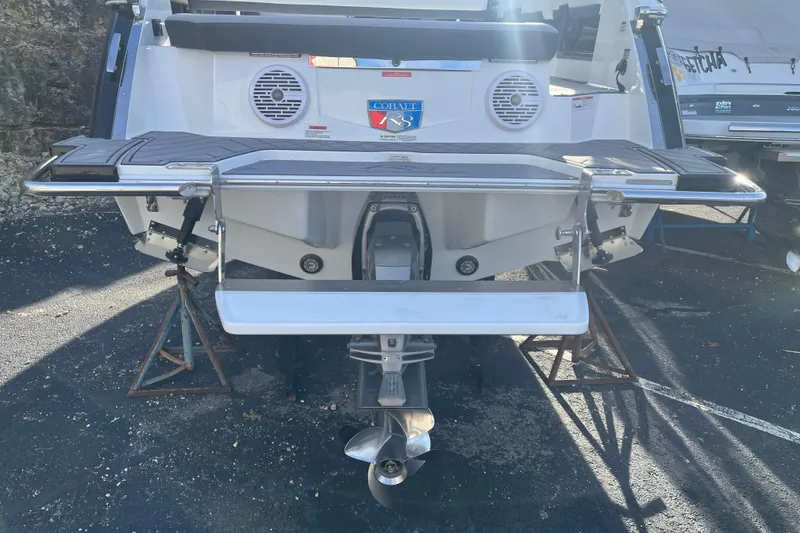 Slide: The Image of 2022 Cobalt R8 boat stern with swim platform and outboard motor, parked on stands. - 13