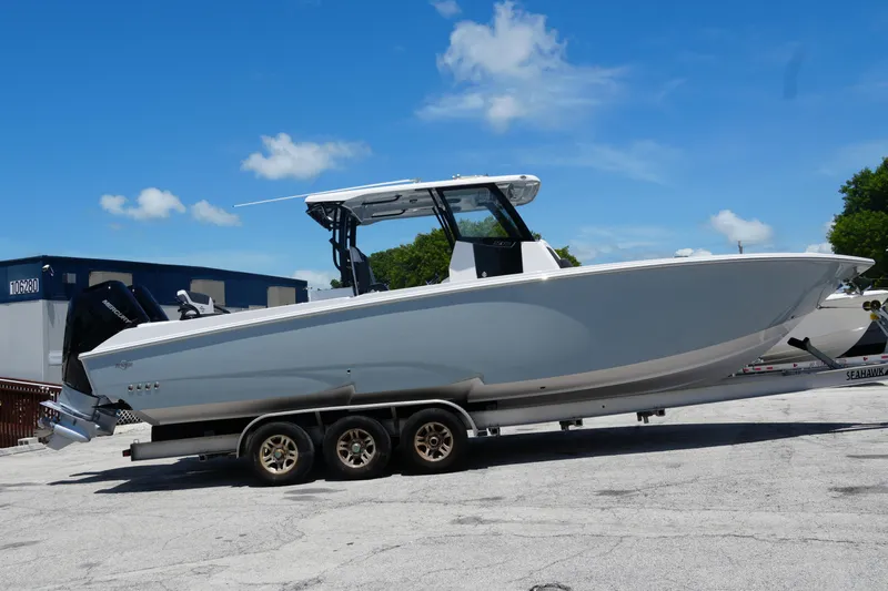 Slide: The Image of 2025 Fountain 32 NX Sportfish boat on trailer under clear blue sky. - 1