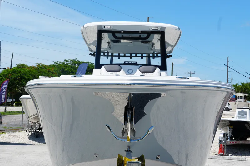Slide: The Image of 2025 Fountain 32 NX Sportfish boat, sleek design, docked under clear blue sky. - 3