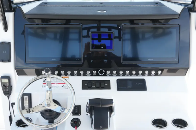 Slide: The Image of 2025 Fountain 32 NX Sportfish dashboard with dual Garmin displays and modern controls. - 7