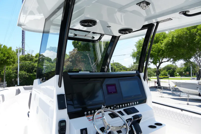 Slide: The Image of 2025 Fountain 32 NX Sportfish boat dashboard with modern controls and steering wheel. - 8