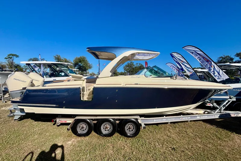 The Image of 2026 Chris-Craft Launch 31 GT boat on trailer, displayed outdoors under clear blue sky. - 0