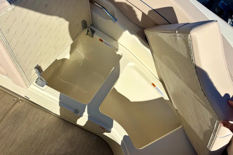 Slide: The Image of 2026 Chris-Craft Launch 31 GT boat storage compartment with beige cushioned seating. - 24