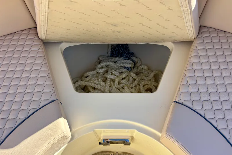 Slide: The Image of 2026 Chris-Craft Launch 31 GT boat storage compartment with ropes and cushioned seating. - 25