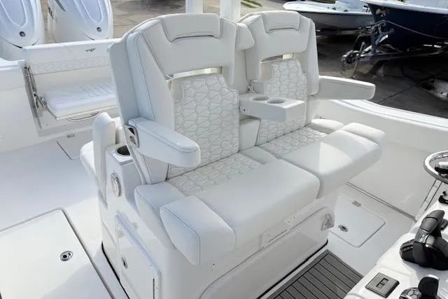 Slide: The Image of 2026 Tidewater 320 CC Adventure boat with luxurious white seating and Garmin electronics. - 10