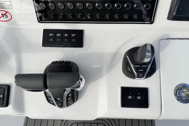 Slide: The Image of Control panel of 2026 Tidewater 320 CC Adventure boat with throttle and joystick. - 13