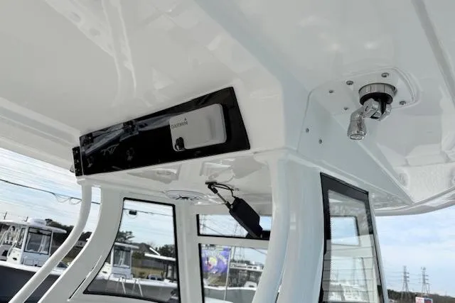 Slide: The Image of 2026 Tidewater 320 CC Adventure boat interior with white cushioned seating and speakers. - 14