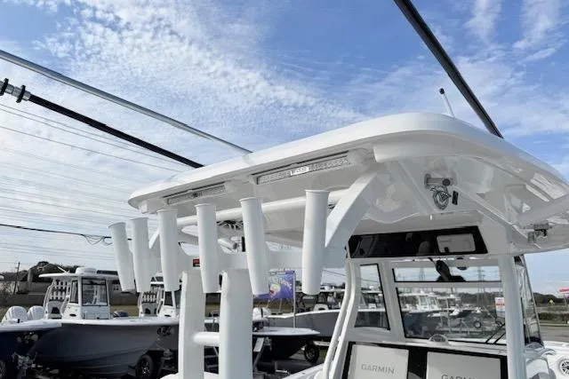 Slide: The Image of 2026 Tidewater 320 CC Adventure boat interior with white cushioned seating and sleek design. - 15