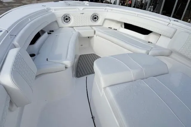 Slide: The Image of 2026 Tidewater 320 CC Adventure boat interior with toilet and cushioned seating. - 16