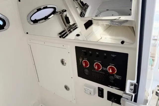 Slide: The Image of 2026 Tidewater 320 CC Adventure boat with Garmin equipment, docked in a marina. - 21