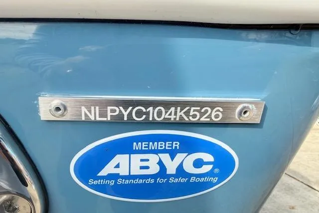 Slide: The Image of 2026 Tidewater 320 CC Adventure boat with rod holders and Garmin electronics under a blue sky. - 24