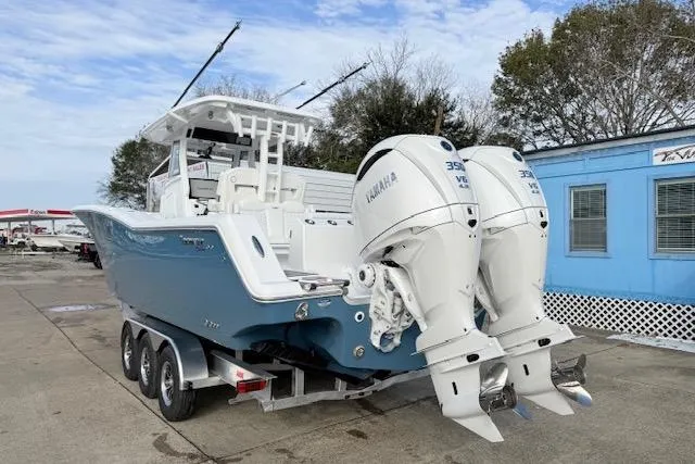 Slide: The Image of 2026 Tidewater 320 CC Adventure boat on trailer, featuring dual Yamaha engines. - 4