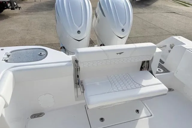 Slide: The Image of 2026 Tidewater 320 CC Adventure boat with dual 350 V6 engines, parked outdoors. - 7