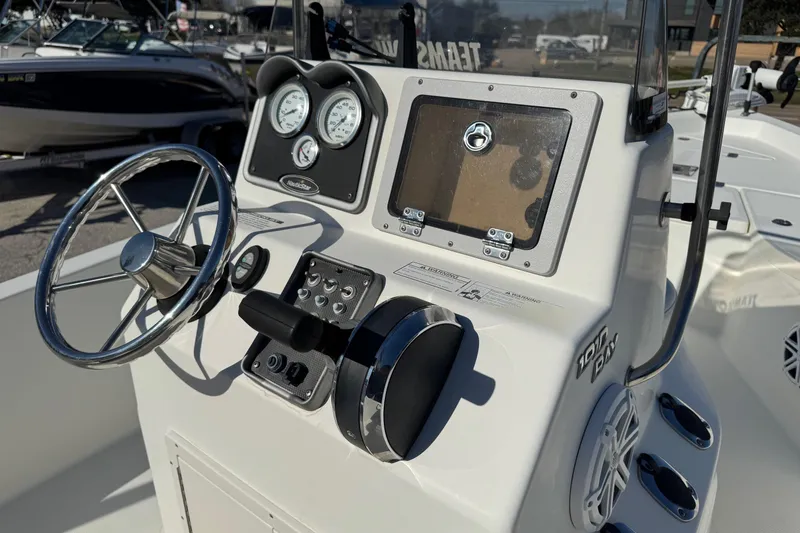 Slide: The Image of 2015 NauticStar 1910 NauticBay boat console with steering wheel and gauges. - 16