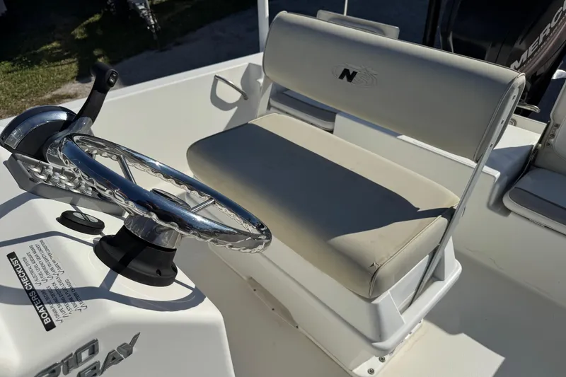 Slide: The Image of 2015 NauticStar 1910 NauticBay boat interior with steering wheel and seating. - 6