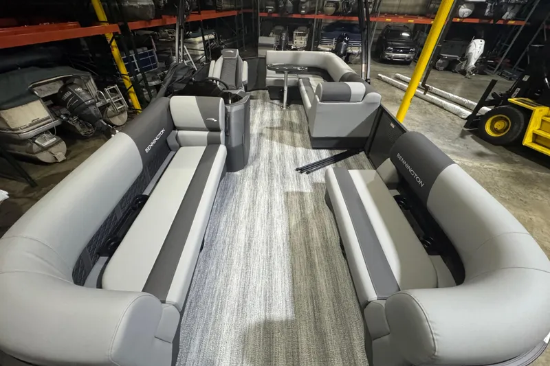 Slide: The Image of 2026 Bennington 20SL pontoon boat interior with gray seating and spacious layout. - 11