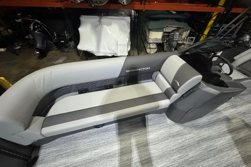 Slide: The Image of 2026 Bennington 20SL boat interior with gray seating and steering console. - 12