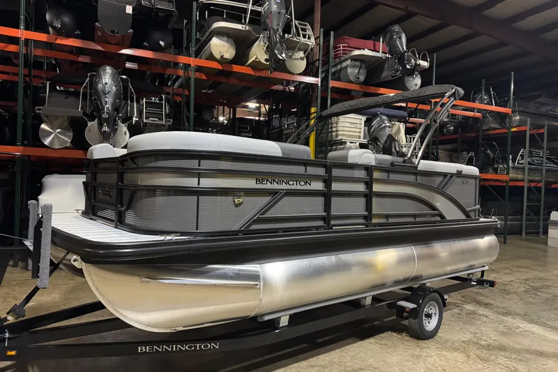 The Image of 2026 Bennington 20SL pontoon boat on trailer in storage facility. - 7
