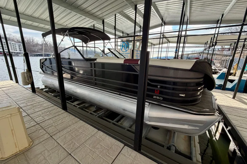 Slide: The Image of ```markdown "Logo of Ozark Yachts & Motorsports, featuring Crest Continental 250 SLS, 2019 model." ``` - 1