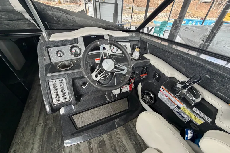 Slide: The Image of 2019 Crest Continental 250 SLS boat interior with white seating and wood flooring. - 16