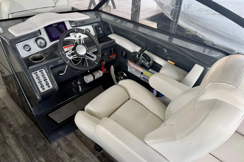 Slide: The Image of 2019 Crest Continental 250 SLS boat dashboard with steering wheel and control panel. - 17