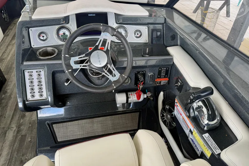 Slide: The Image of Interior of a 2019 Crest Continental 250 SLS boat with steering wheel and controls. - 18