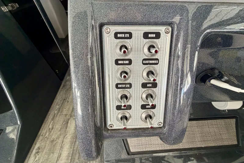 Slide: The Image of Control panel of 2019 Crest Continental 250 SLS boat with throttle lever and safety features. - 23