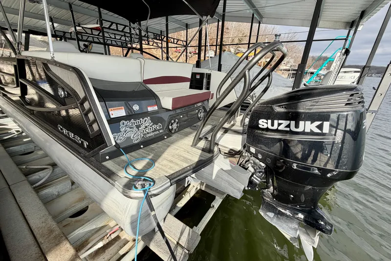 Slide: The Image of 2019 Crest Continental 250 SLS pontoon boat docked with Suzuki outboard motor. - 3