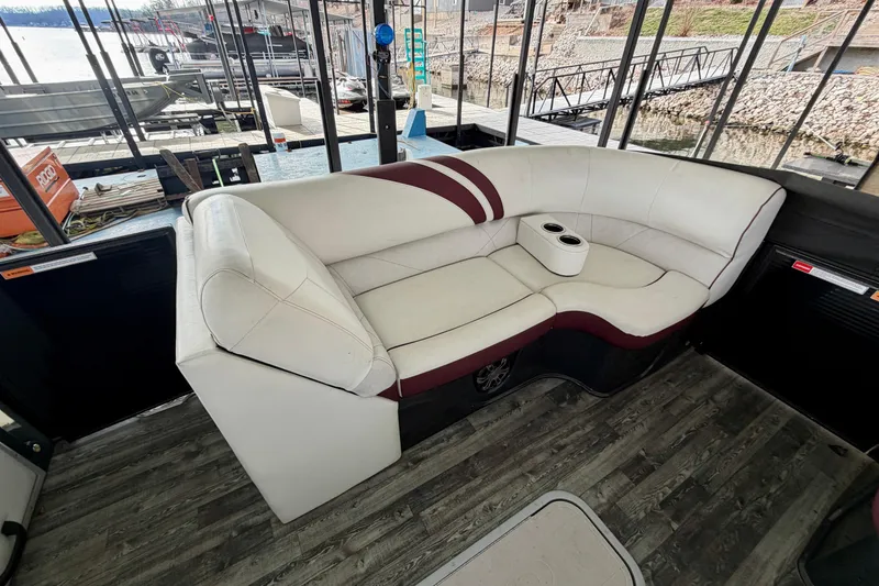 Slide: The Image of Luxurious seating on a 2019 Crest Continental 250 SLS boat with cup holders and wood flooring. - 31