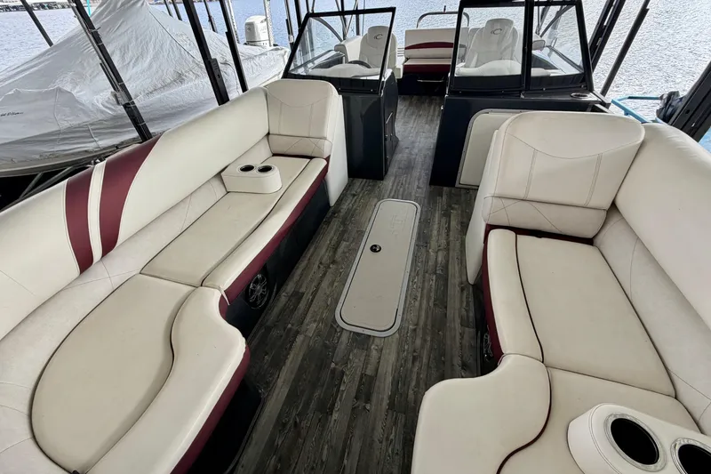 Slide: The Image of 2019 Crest Continental 250 SLS boat interior with storage compartment and seating. - 34