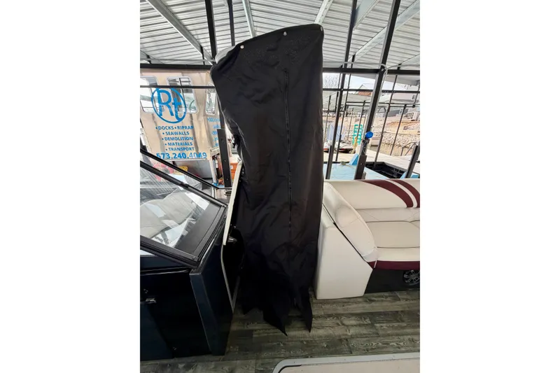 Slide: The Image of Storage compartment in 2019 Crest Continental 250 SLS boat, featuring wood-patterned flooring. - 37