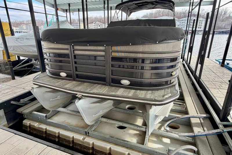 Slide: The Image of 2019 Crest Continental 250 SLS pontoon boat with Suzuki outboard motor docked at marina. - 4