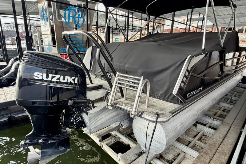 Slide: The Image of 2019 Crest Continental 250 SLS pontoon boat with Suzuki outboard motor docked. - 8
