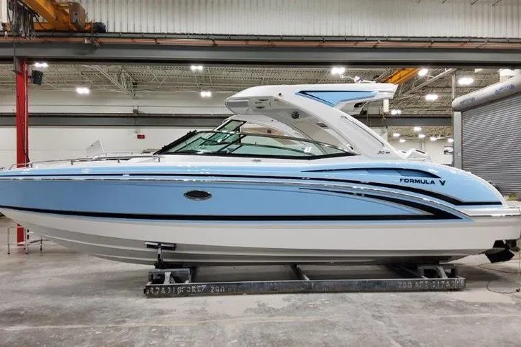 The Image of 2025 Formula 310 Bowrider I/O boat in a showroom, showcasing sleek design and modern features. - 0
