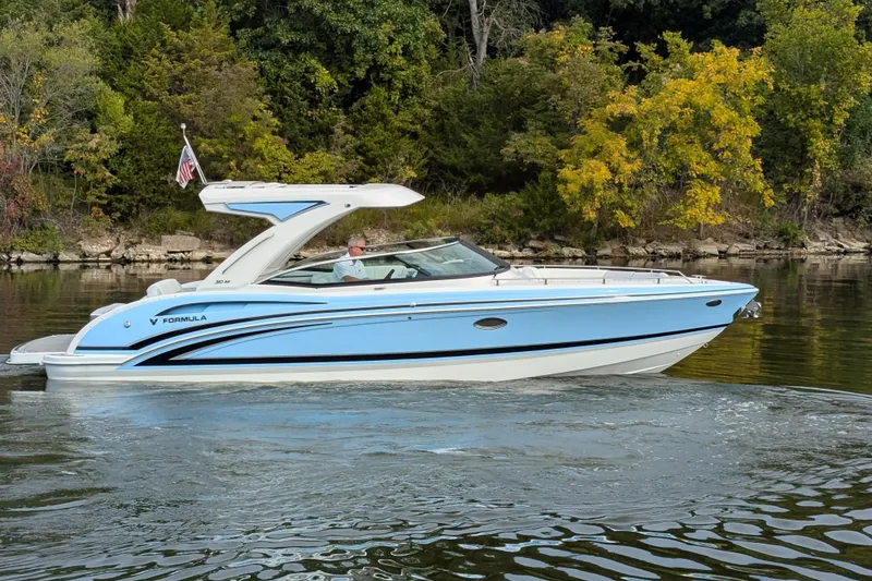 Slide: The Image of 2025 Formula 310 Bowrider I/O boat cruising on a scenic lake. - 12