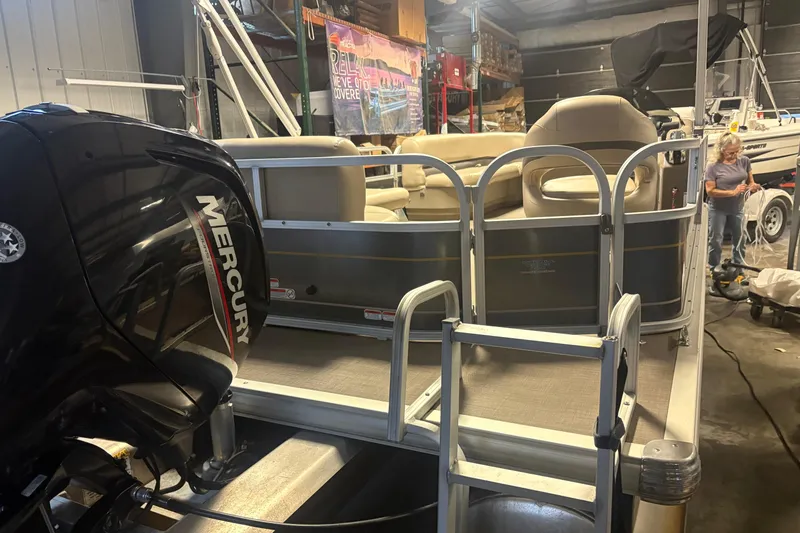 Slide: The Image of 2020 Sun Tracker Party Barge 18 DLX pontoon boat with Mercury engine in a garage. - 4