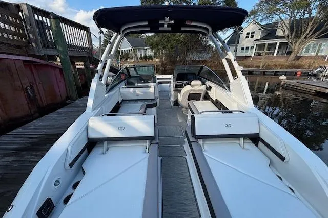 Slide: The Image of 2021 Cobalt R6 Outboard boat with spacious seating, docked near waterfront homes. - 13