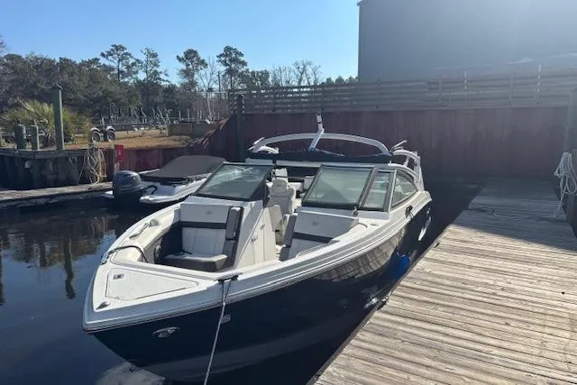 Slide: The Image of 2021 Cobalt R6 Outboard boat docked, featuring sleek design and spacious seating. - 2