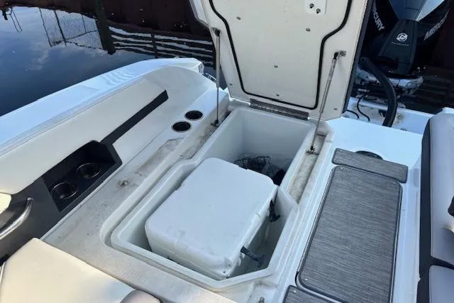 Slide: The Image of 2021 Cobalt R6 Outboard boat with open storage compartment and cooler. - 28