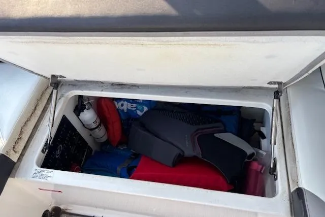 Slide: The Image of Storage compartment of 2021 Cobalt R6 Outboard boat with safety gear and equipment. - 30