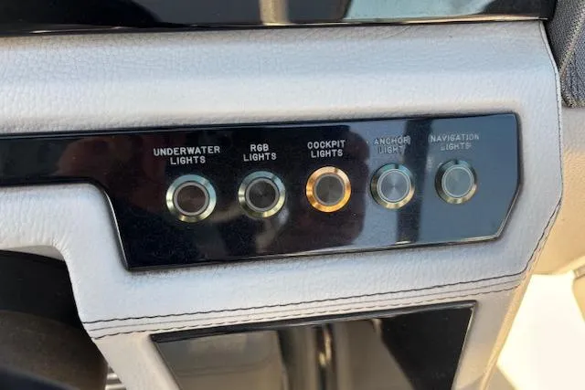Slide: The Image of Control panel of a 2021 Cobalt R6 Outboard boat with light switches. - 35