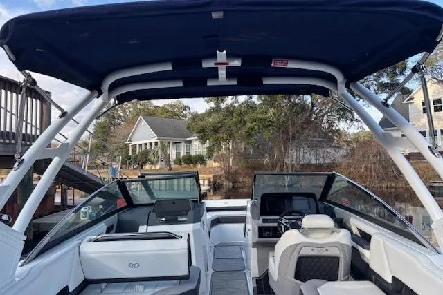 Slide: The Image of 2021 Cobalt R6 Outboard boat with canopy, docked near waterfront homes. - 38