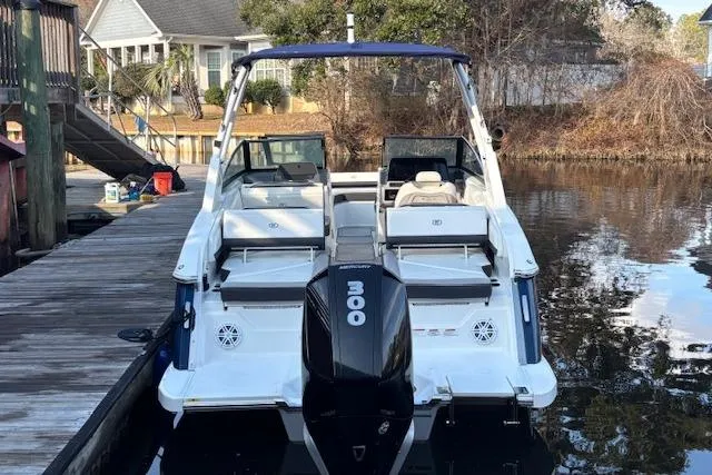 Slide: The Image of 2021 Cobalt R6 Outboard boat docked by a serene waterfront. - 5
