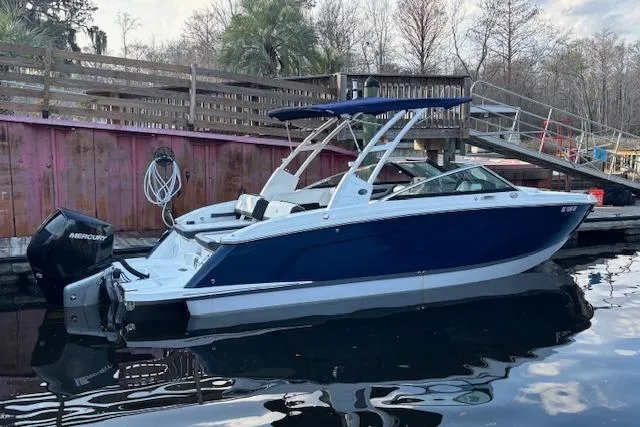 Slide: The Image of 2021 Cobalt R6 Outboard boat docked, featuring sleek design and Mercury engine. - 7