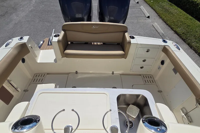 Slide: The Image of 2021 Scout 305 LXF boat interior with seating and sink, showcasing luxury design. - 10
