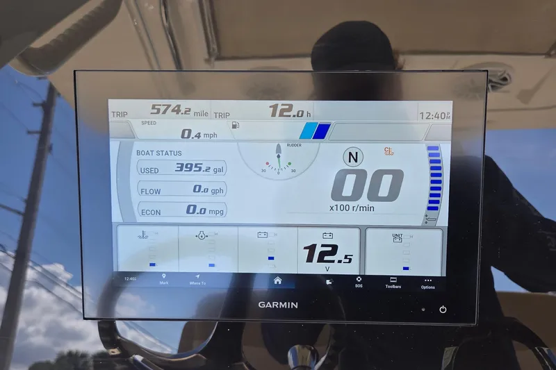 Slide: The Image of Garmin display on 2021 Scout 305 LXF showing trip data and boat status. - 12