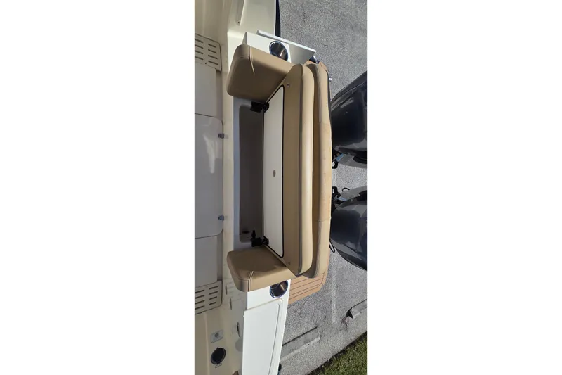 Slide: The Image of 2021 Scout 305 LXF boat with tan seating and dual engines, viewed from above. - 15