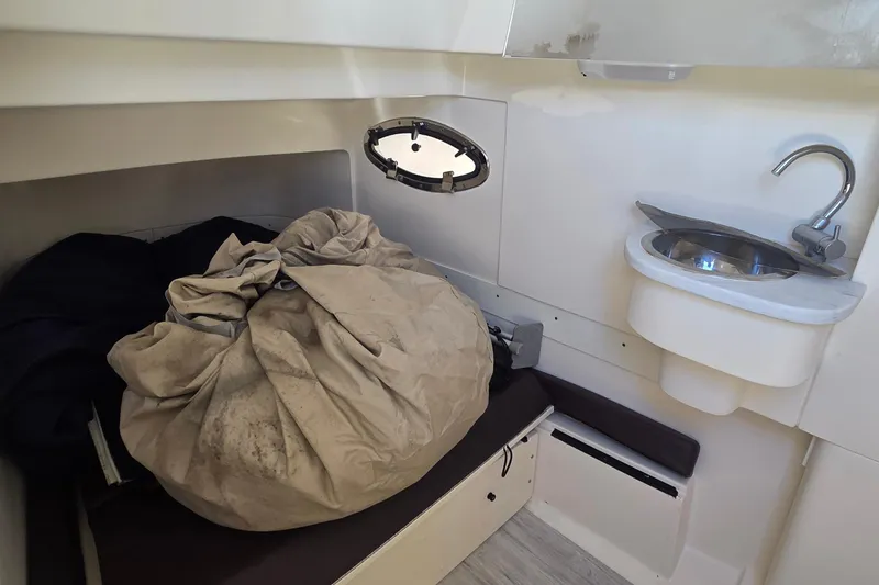 Slide: The Image of 2021 Scout 305 LXF cabin interior with sink and storage area. - 19