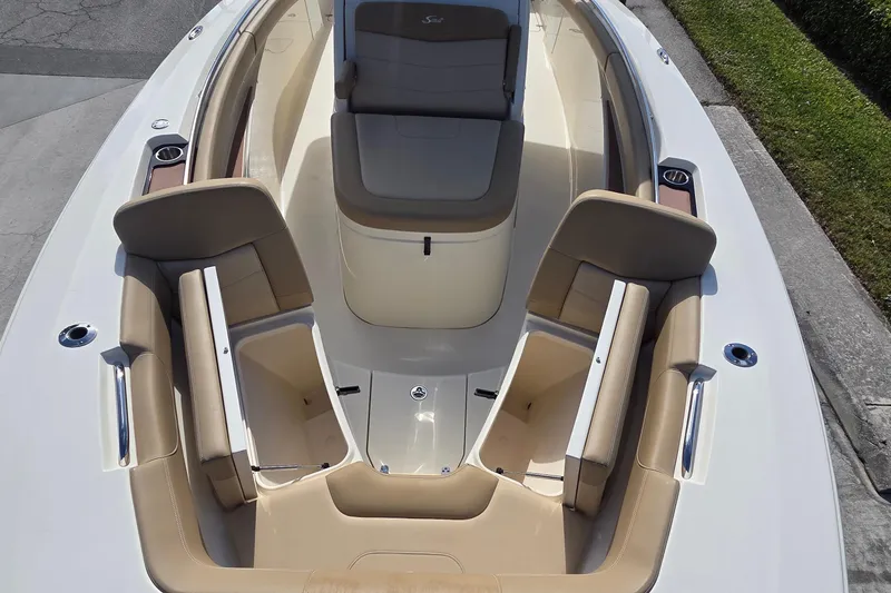 Slide: The Image of 2021 Scout 305 LXF boat interior with beige seating and storage compartments. - 20