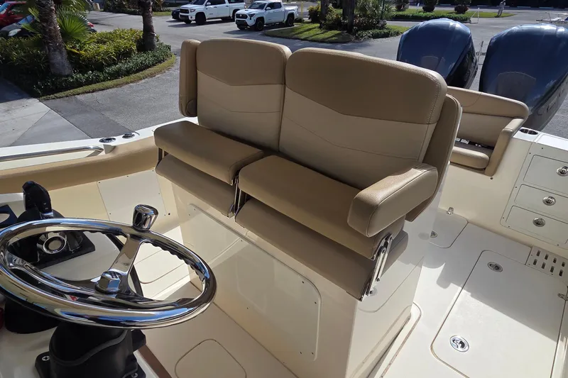 Slide: The Image of 2021 Scout 305 LXF boat interior with dual helm seats and steering wheel. - 23
